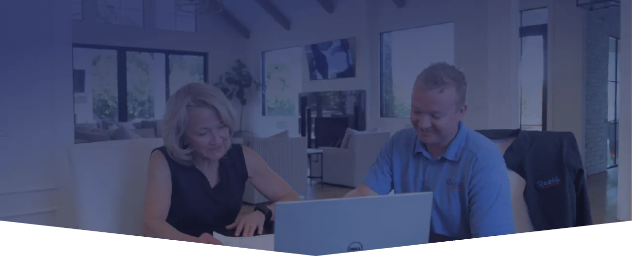 A Reeis specialist talking with a homeowner about their home